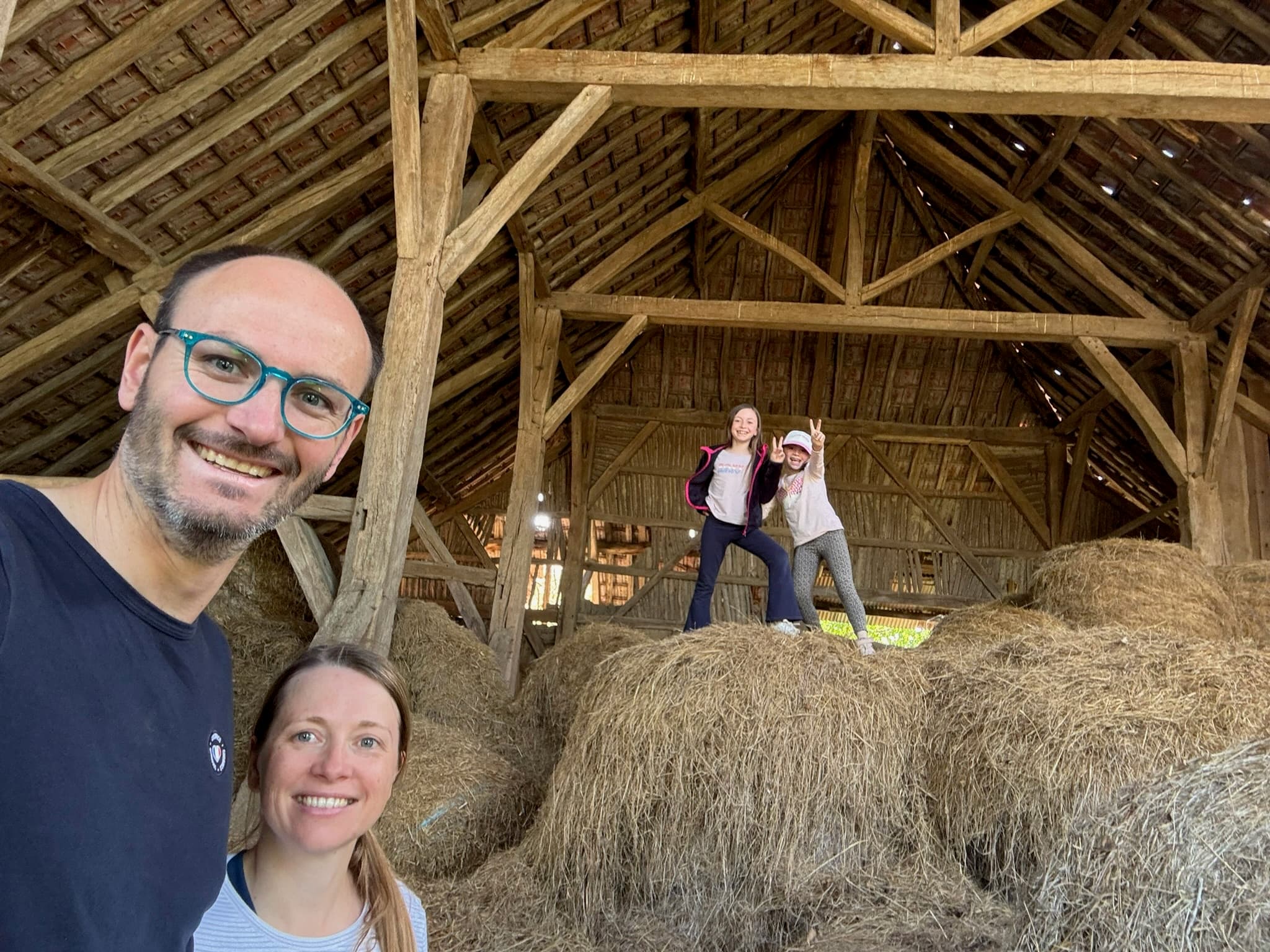 Céline & Sébastien LeSeurre and their daughters inside the historic barn.